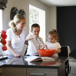 family cooking in new home kitchen