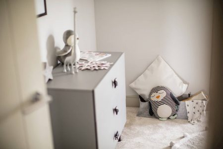 stylish grey childrens bedroom with stuffed toys