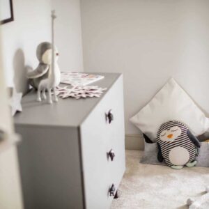 stylish grey childrens bedroom with stuffed toys